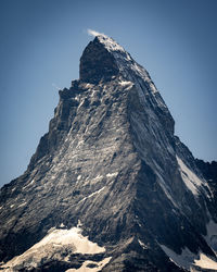 Scenic view of snowcapped mountains against clear blue sky