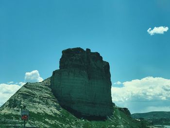 Low angle view of mountain against blue sky