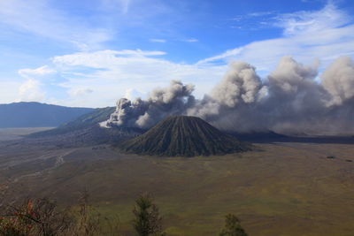 Panoramic view of volcanic landscape against cloudy sky