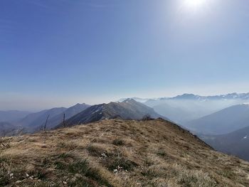 Scenic view of mountains against clear blue sky