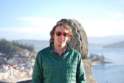 Portrait of smiling young man wearing sunglasses outdoors