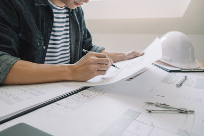 Midsection of man working on table