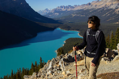 Portrait of man standing by lake