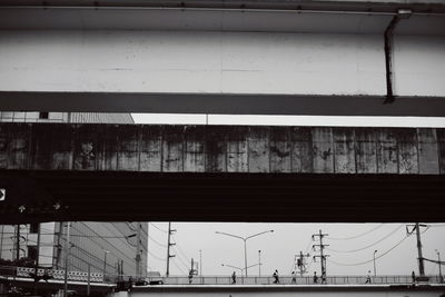 Low angle view of crane bridge against sky