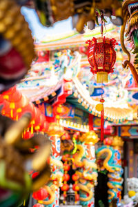 Close-up of decorations hanging in market for sale