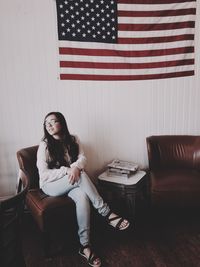 Portrait of young woman sitting on bench