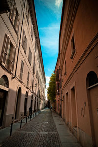 Street amidst buildings against sky