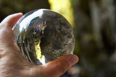 Close-up of hand holding crystal ball