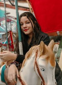 Portrait of smiling young woman in amusement park