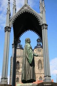 Low angle view of statue against temple