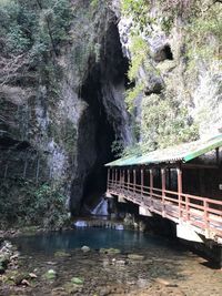 Bridge over river against rock formation