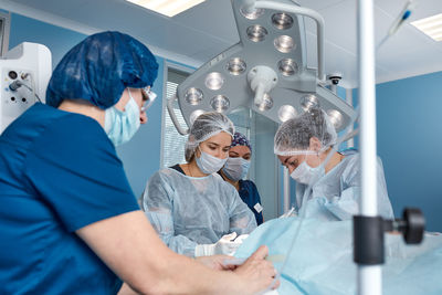 Midsection of female friends standing in laboratory