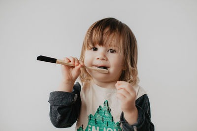 Girl brushing teeth with toothbrush