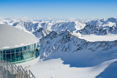 Cropped structure on snow landscape against clear blue sky