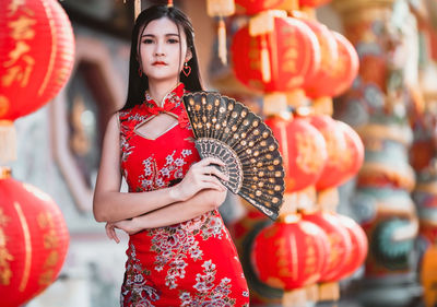 Full length portrait of woman standing outdoors