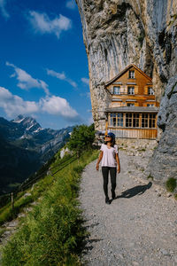Full length of woman standing on mountain road