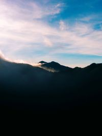 Scenic view of silhouette mountains against sky at sunset