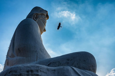 Low angle view of statue against sky