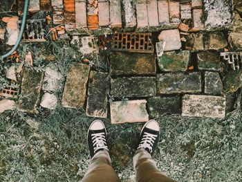 Low section of man standing on tiled floor