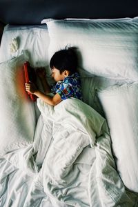 High angle view of baby sleeping in bed
