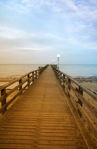 Pier over sea against sky