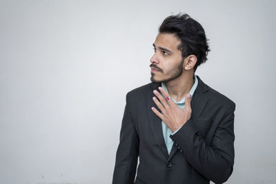 Man looking away against white background