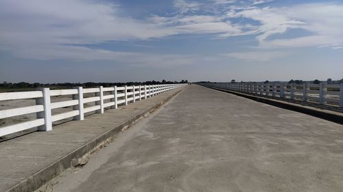 View of bridge over calm sea against sky