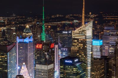 Aerial view of city lit up at night