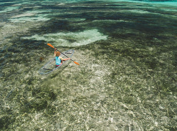 High angle view of woman on inflatable boat in sea