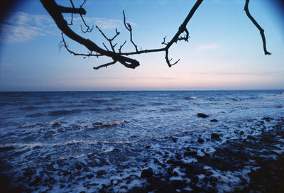 Scenic view of sea against sky at sunset