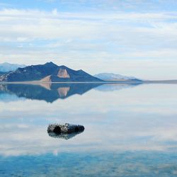 Scenic view of lake against cloudy sky