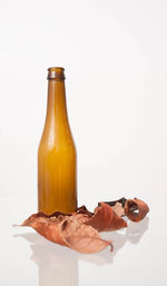 Close-up of drink on table against white background