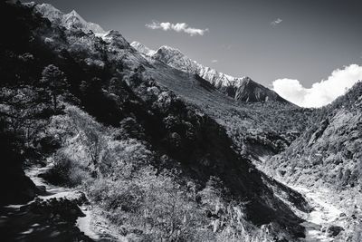 Scenic view of mountains against cloudy sky