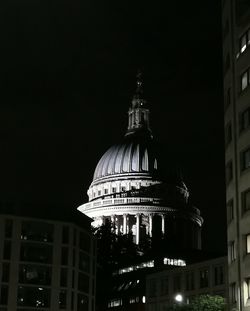 Low angle view of illuminated building against sky at night