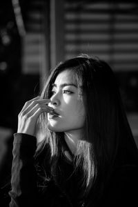 Close-up portrait of young woman looking away