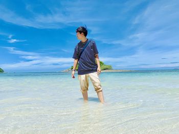 Full length of man standing on beach