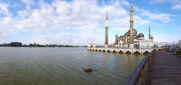 View of mosque against cloudy sky