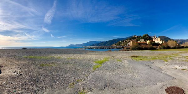 Scenic view of beach against blue sky