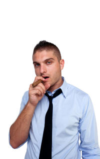 Portrait of man smoking cigar against white background