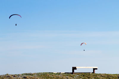 Person paragliding against sky