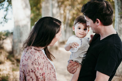 Rear view of mother and daughter outdoors