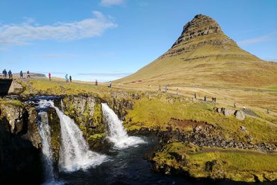 Kirkjufellsfoss waterfall with kirkjufell mountain in the background on a fall afternoon.