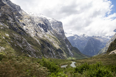 Scenic view of mountains against cloudy sky