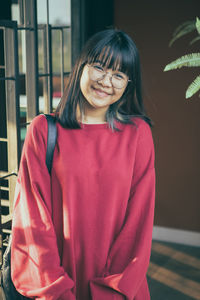 Asian teenager wearing red casual with smiling face