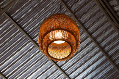 Low angle view of illuminated pendant lights hanging from ceiling