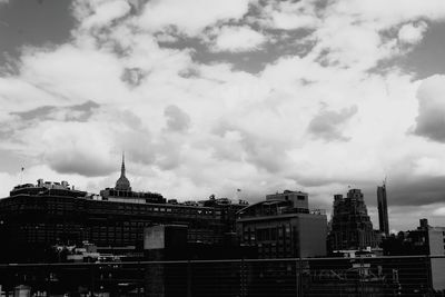 Cityscape against cloudy sky