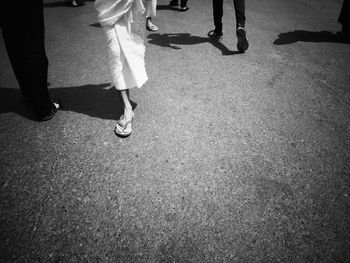 Low section of people walking on road