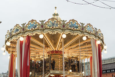 Low angle view of illuminated ferris wheel against sky