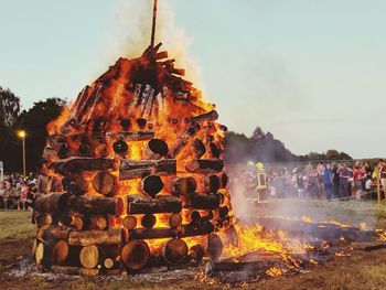 Group of people in temple against sky fire