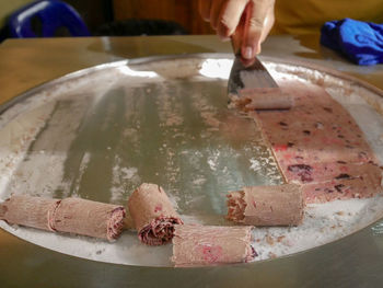 Close-up of person preparing food on table